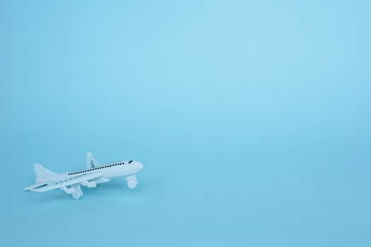 White airplane model on blue background for vehicle and transportation concept