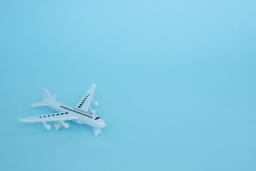 White airplane model on blue background for vehicle and transportation concept