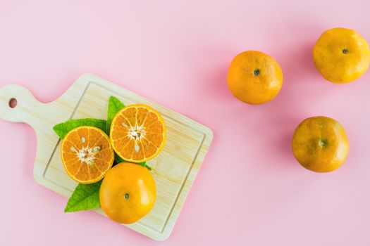 Orange on pink background for fruit and eating concept