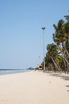 Beautiful beach with white sand, coconut tree and blue and clear sky background for travel and nature concept