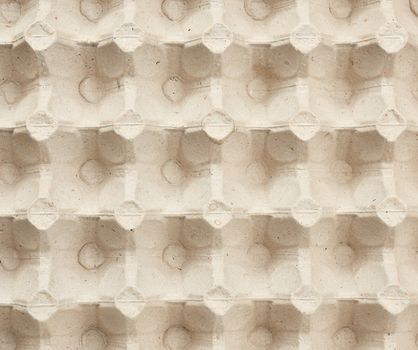 volumetric texture of a beige paper egg tray, full frame, close up