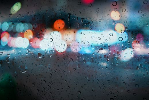 Raindrops with light bokeh on the road rain season background