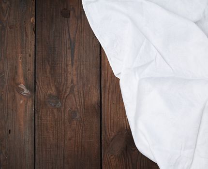 white linen towel on wooden background, top view, copy space