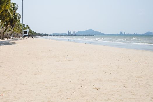 Beautiful beach with white sand, coconut tree and blue and clear sky background for travel and nature concept