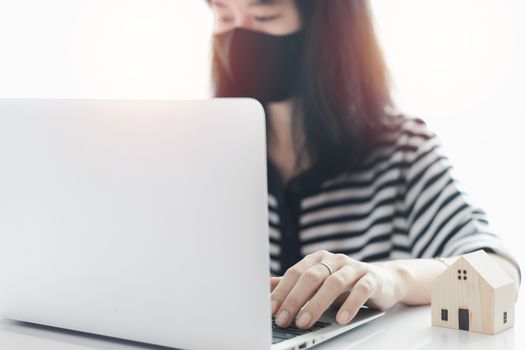 Woman using laptop and working at home for business, self-quarantine, staying home and social distancing in coronavirus or Covid-2019 outbreak situation concept