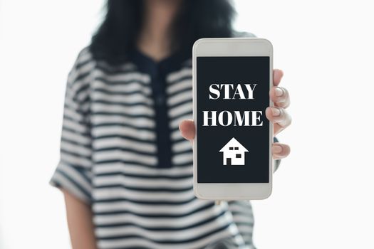 Woman's hand holding smartphone with alert notification for self-quarantine, staying home and social distancing in coronavirus or Covid-2019 outbreak situation concept