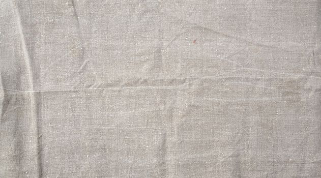 fragment of a very old gray linen homespun fabric, full frame