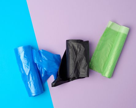 rolled up rolls with plastic garbage bags on a blue background