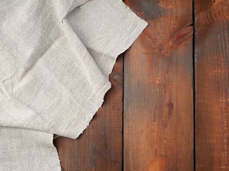 gray linen towel on wooden background, top view, copy space