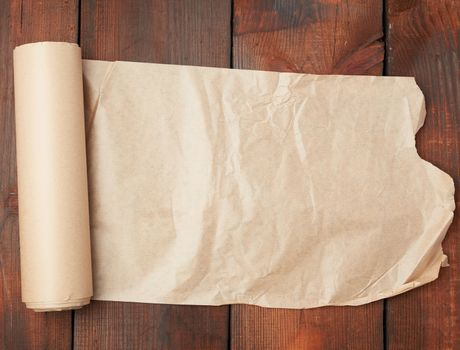 roll of untwisted brown paper on a wooden surface from old boards, copy space
