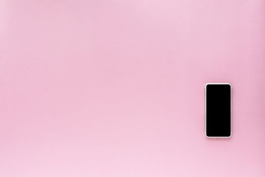 Smartphone on pink background with copy space for communication and media technology concept