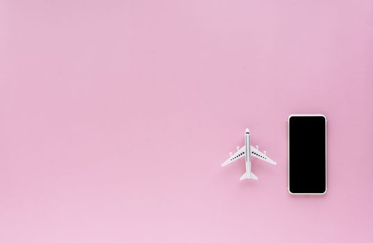 Blank screen of smartphone with white airplane model on pink background with copy space for contact, booking flight ticket and travel concept