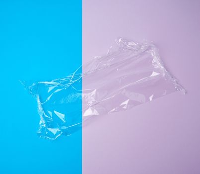 transparent white polyethylene for wrapping products and packaging goods on a colored background, top view