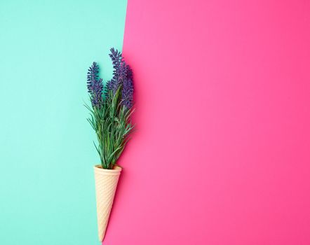 lavender bouquet and red ribbon on a color background, top view, copy space