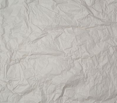 empty gray crumpled sheet of paper, full frame, close up
