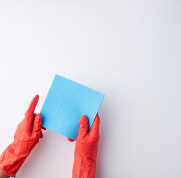 blue square absorbent sponges in their hands wearing red rubber gloves, white background, top view, place for text