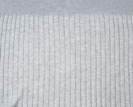 fragment of gray knitted fabric, full frame, fabric for sweaters, close up