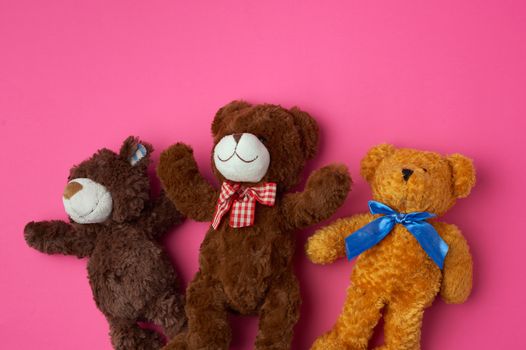 three teddy bears on a pink background, friendship concept, close up