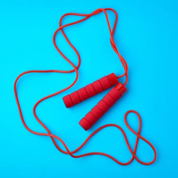 red rope for sports on a blue background, two neoprene handle