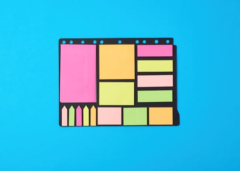 various blank paper multicolored stickers on a black background, close up