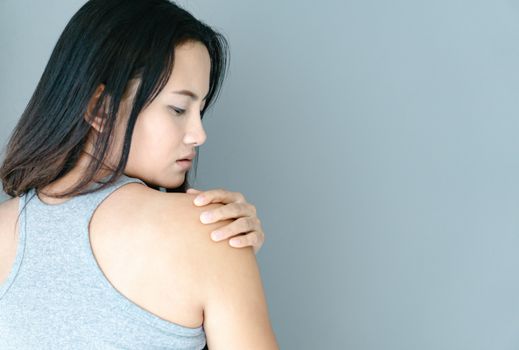 Closeup woman hand holding shoulder with pain on white background