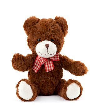 little cute brown teddy bear with a red bow on his neck isolated on a white background