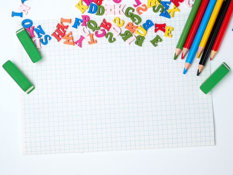 blank white sheet of squared papers and school supplies, back to school