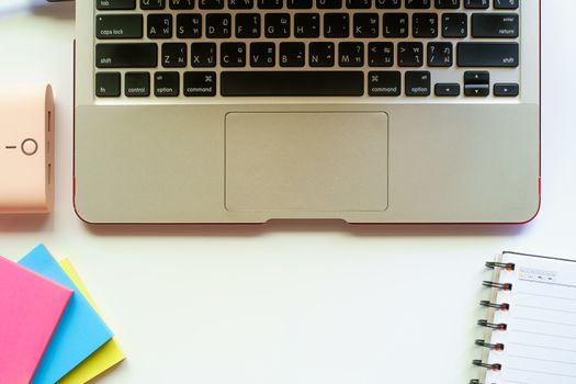 Top view of computer laptop and the other office accessories on the white table workplace