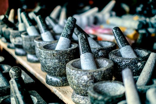 Selective focus of granite stone mortar and pestle, the famous Thai kitchenware product at Ang Sila, Chonburi, Thailand