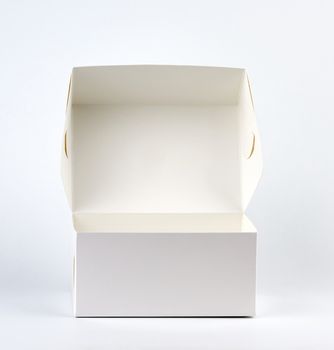 empty open white cardboard box on a white background, close up