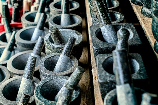 Selective focus of granite stone mortar and pestle, the famous Thai kitchenware product at Ang Sila, Chonburi, Thailand