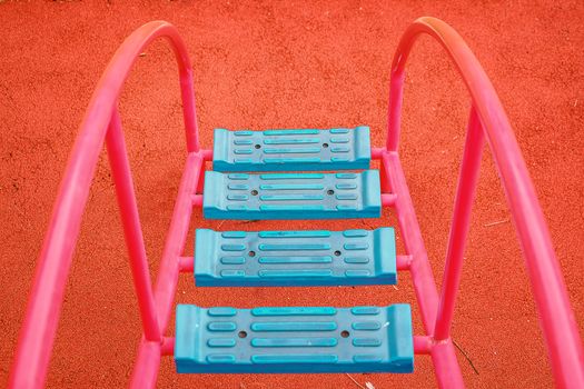 Top view of blue ladder for kids to walk up to playground equipment