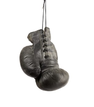 very old black right boxing glove hanging on a cord isolated on white background