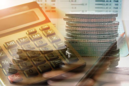 Double exposure of coins with calculator and book bank account for finance concept