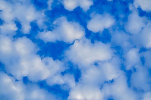 Fluffy white clouds on blue sky in the early morning