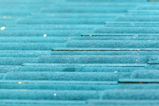 Close up of green concrete roof tile with soft light and shallow DOF