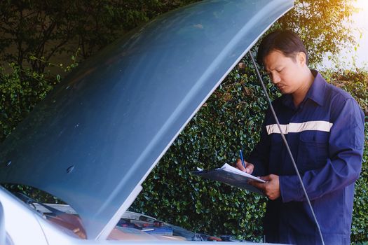 Man checking the items to repair the car