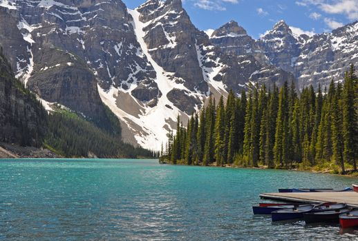Beautiful view of the rockies at Moraine Lake in Banff National Park. With dock and canoes.