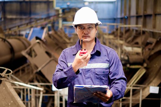 Engineer working in the production line process of granular coal plant