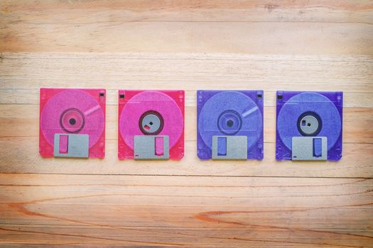 Front and back of floppy disk on wooden table, old technology and legacy industrial computer equipment
