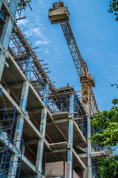 Building construction site and crane against blue sky