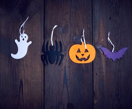 colorful felt figures on a wooden background, festive backdrop for Halloween