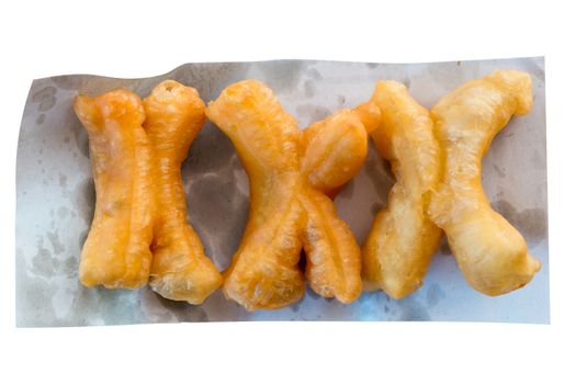 Deep-fried dough stick on the oil blotting paper with a white background