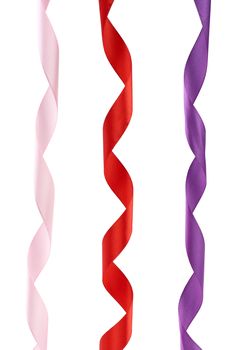 pink, red and purple satin twisted ribbons isolated on white background, close up