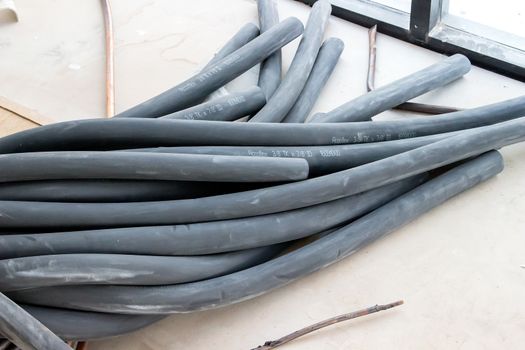 Rubber tubes and wires lay on the cement floor.