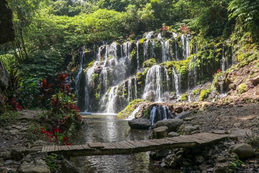 Beautiful waterfall of Banyu Wana Amertha in tropical jungle. Scenic with rock. Picturesque waterfall cascade in Bali.