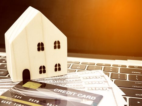 Small wooden houses with modern design and Credit card for home loans concept.