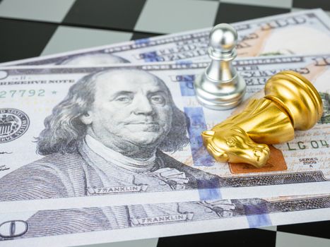 Financial games concept, Game of chess with dollar money, selective focus.