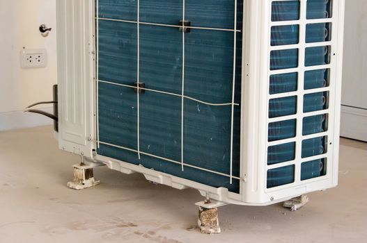 Residential air conditioner condenser unit inside a house