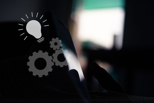 Interlocking cogs lead to good ideas, virtual dashboard diagrams on the smartphone background.